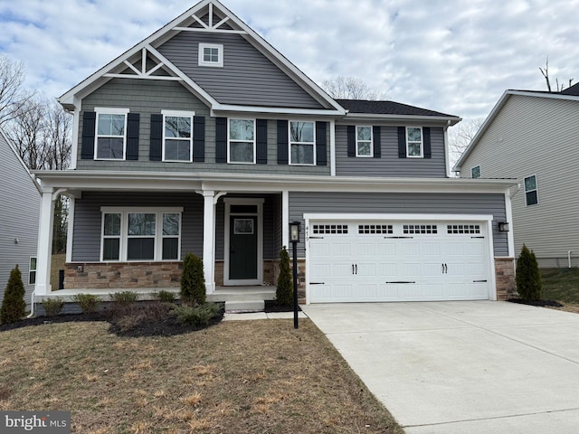 craftsman inspired home with a garage, a front yard, and a porch