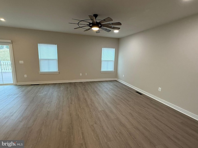 unfurnished room with hardwood / wood-style flooring and ceiling fan