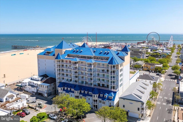 bird's eye view with a water view and a beach view