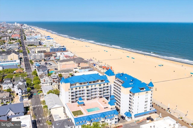 bird's eye view featuring a water view and a beach view