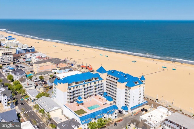 bird's eye view with a water view and a beach view