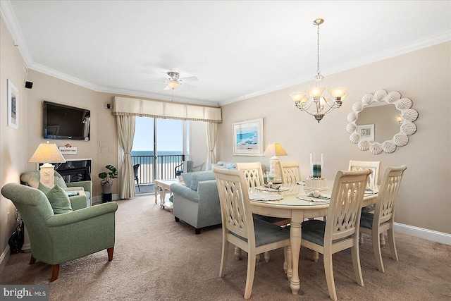 carpeted dining space with crown molding and ceiling fan with notable chandelier