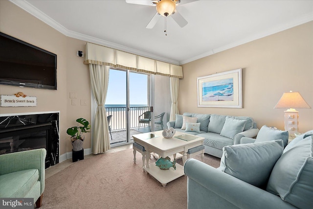 carpeted living room featuring crown molding, a water view, and ceiling fan