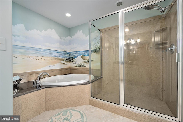 bathroom featuring tile patterned floors and tiled tub