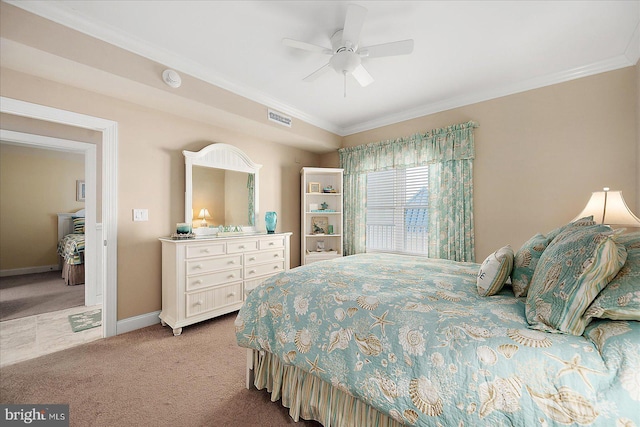 carpeted bedroom with ornamental molding and ceiling fan