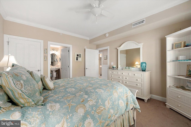 bedroom featuring ornamental molding, carpet flooring, ceiling fan, and ensuite bath