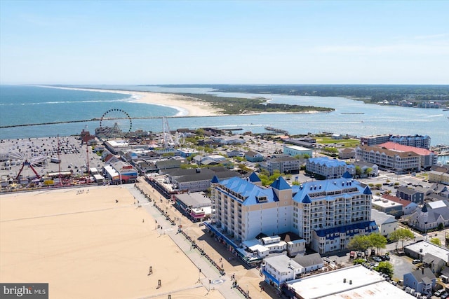 bird's eye view featuring a water view and a beach view