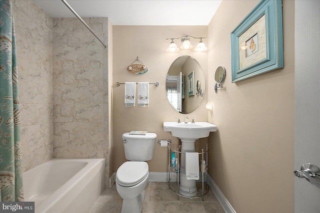 bathroom featuring tile patterned flooring, shower / bath combo, and toilet