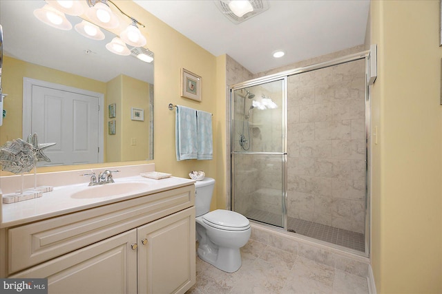 bathroom with an enclosed shower, vanity, and toilet