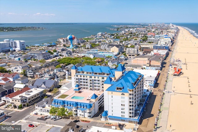 birds eye view of property featuring a water view and a beach view