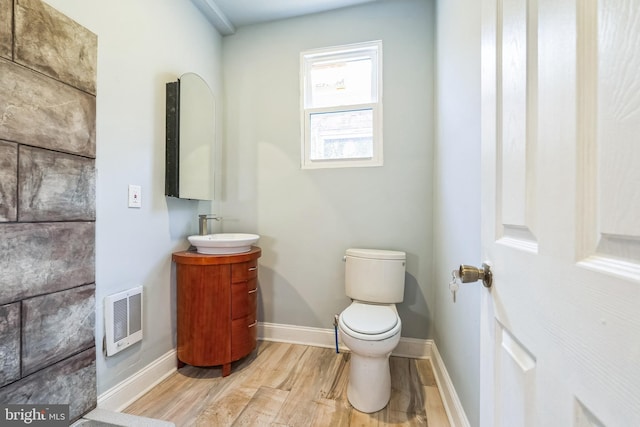 bathroom with vanity, hardwood / wood-style floors, and toilet