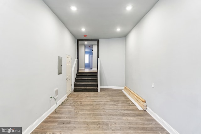 staircase with hardwood / wood-style flooring