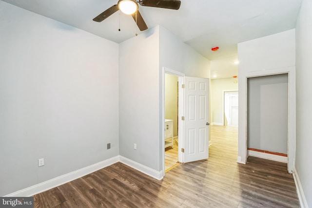 unfurnished bedroom with ceiling fan, connected bathroom, and hardwood / wood-style floors