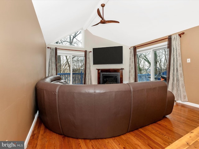 living room featuring hardwood / wood-style flooring, plenty of natural light, lofted ceiling, and ceiling fan