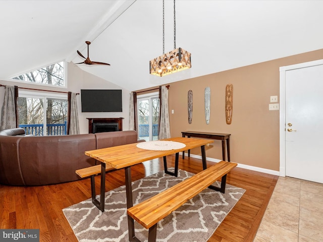 dining room with ceiling fan, wood-type flooring, and lofted ceiling with beams