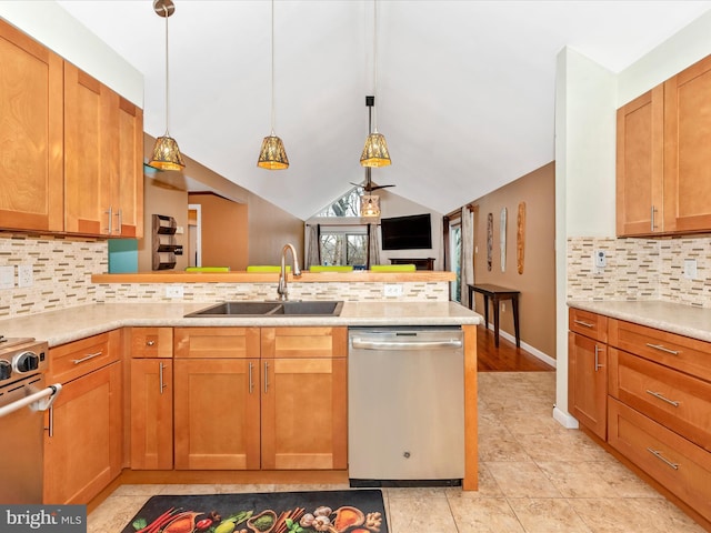 kitchen featuring pendant lighting, sink, vaulted ceiling, and dishwasher