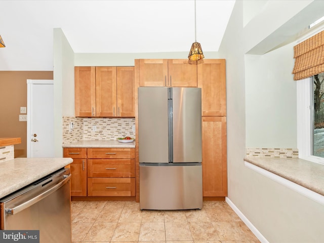 kitchen featuring pendant lighting, decorative backsplash, light tile patterned flooring, and appliances with stainless steel finishes