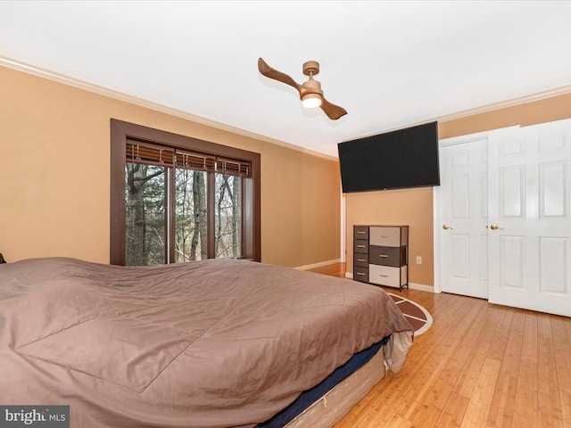 bedroom featuring crown molding, ceiling fan, and hardwood / wood-style flooring