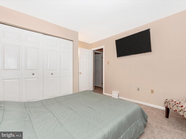 bedroom featuring a closet and light carpet