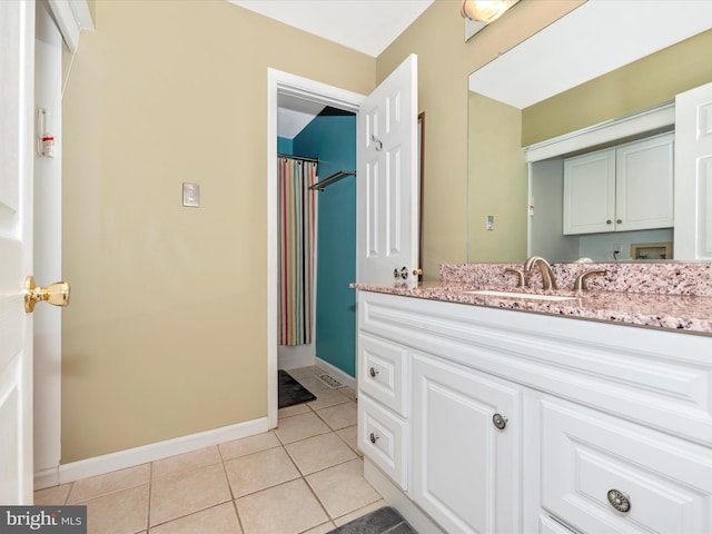 bathroom with tile patterned flooring and vanity