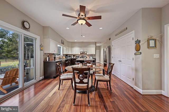 dining space with wood-type flooring and ceiling fan