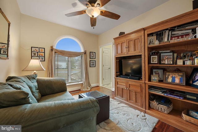 living room featuring ceiling fan and light hardwood / wood-style floors