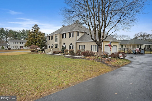 view of front facade with a garage and a front lawn