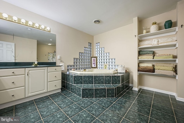 bathroom featuring vanity, tiled bath, and tile patterned floors