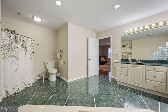 bathroom featuring vanity, tile patterned floors, and toilet