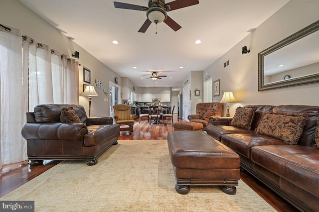 living room featuring hardwood / wood-style flooring and ceiling fan