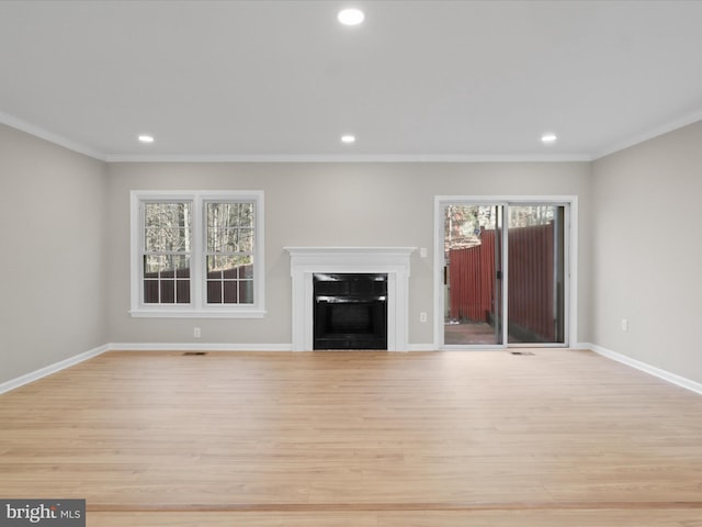 unfurnished living room featuring ornamental molding and light hardwood / wood-style floors