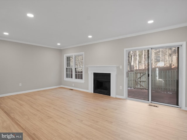 unfurnished living room featuring crown molding and light hardwood / wood-style floors