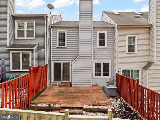 back of house with a wooden deck and central AC unit