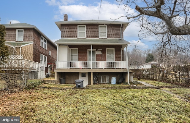 back of house featuring a porch and a yard