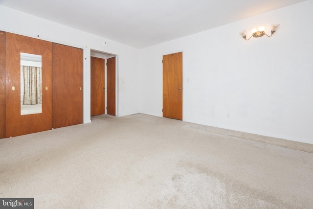 spare room featuring light colored carpet