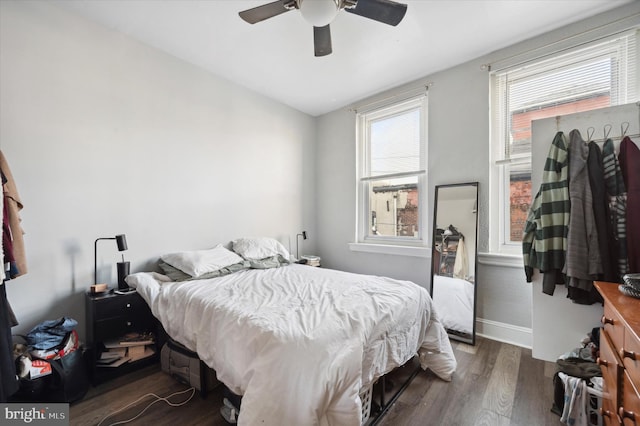 bedroom featuring ceiling fan, dark hardwood / wood-style floors, and vaulted ceiling