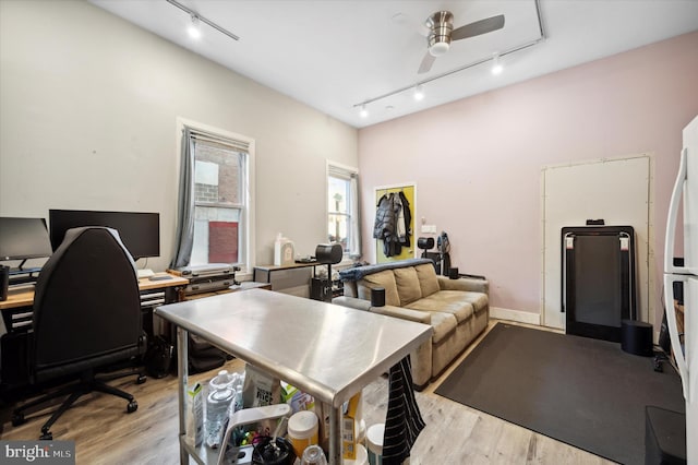 home office with ceiling fan, rail lighting, and light wood-type flooring