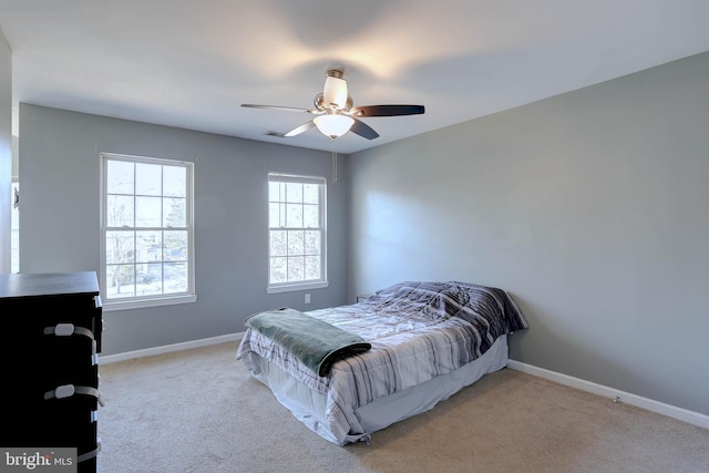 bedroom with ceiling fan and light carpet