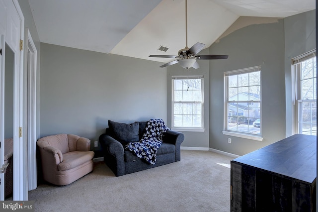 living room featuring a healthy amount of sunlight, light colored carpet, lofted ceiling, and ceiling fan