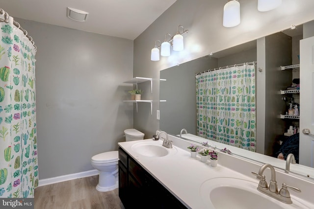 bathroom featuring hardwood / wood-style flooring, vanity, toilet, and walk in shower