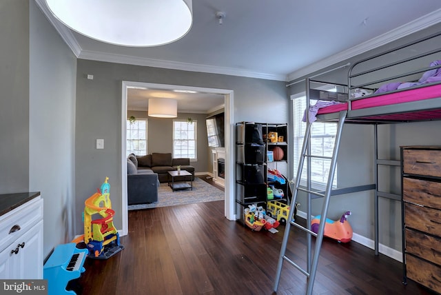 bedroom with dark hardwood / wood-style flooring and crown molding