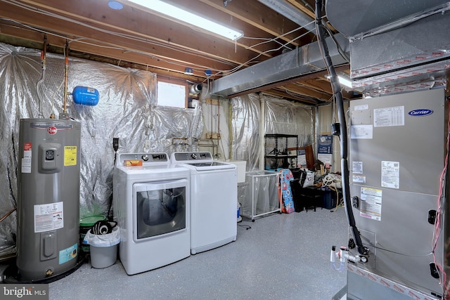 washroom with water heater and washer and dryer