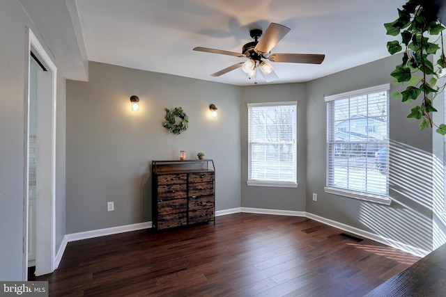 unfurnished bedroom featuring dark hardwood / wood-style flooring and ceiling fan