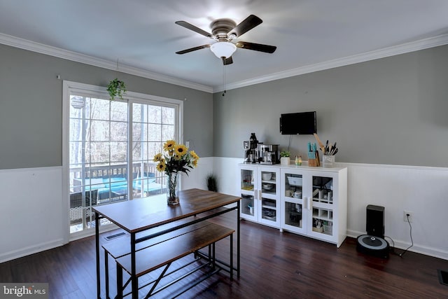 dining room with dark hardwood / wood-style flooring, ornamental molding, and ceiling fan