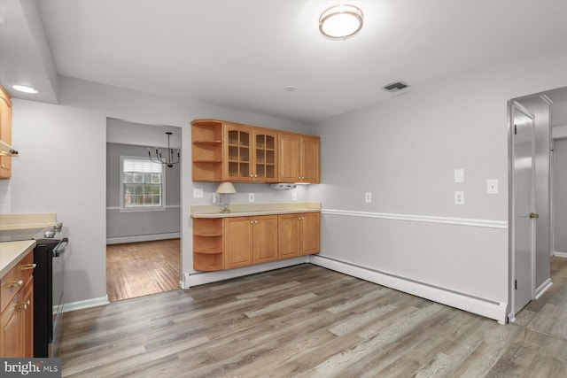 kitchen featuring a baseboard heating unit, black electric range oven, a chandelier, and light hardwood / wood-style flooring