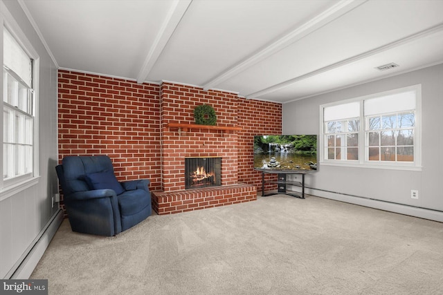 living room featuring beamed ceiling, a healthy amount of sunlight, a brick fireplace, and a baseboard heating unit