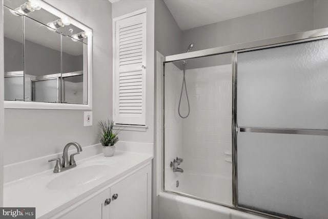 bathroom with vanity and combined bath / shower with glass door