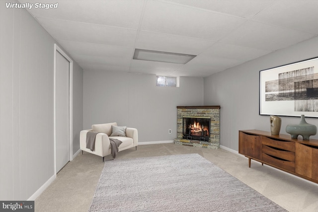 sitting room with a paneled ceiling and light colored carpet