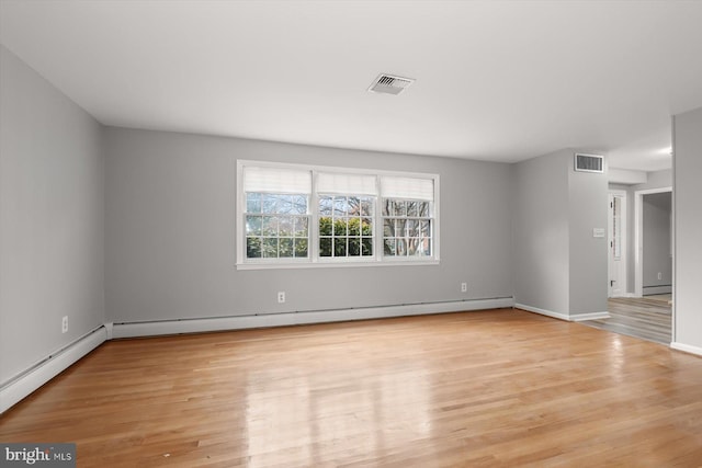 spare room with light hardwood / wood-style flooring and baseboard heating