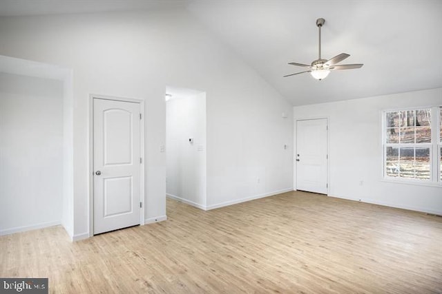 empty room with high vaulted ceiling, ceiling fan, and light hardwood / wood-style flooring